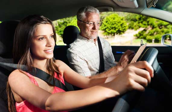 Smiling Female Tearing L Plate after Passing the Driving Test